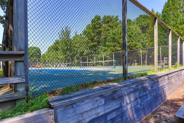 view of swimming pool with tennis court