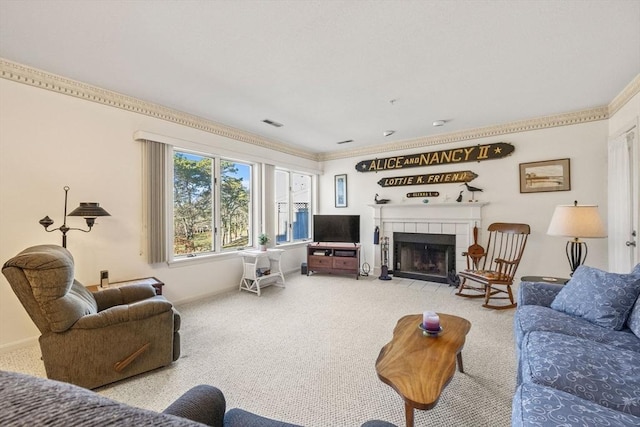 carpeted living room with ornamental molding and a tiled fireplace