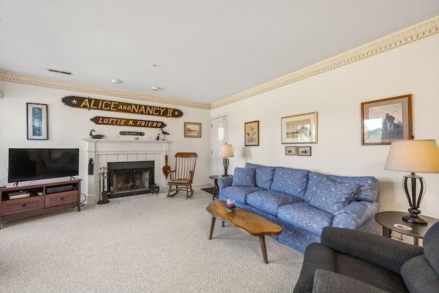 carpeted living room with ornamental molding and a tiled fireplace