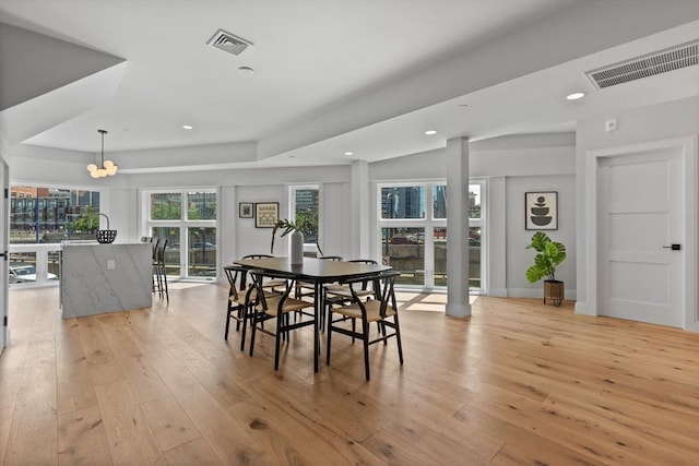 dining room featuring a notable chandelier and light hardwood / wood-style floors