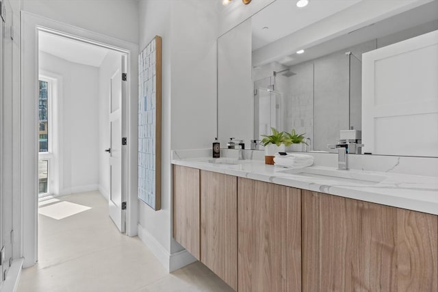 bathroom featuring tile patterned floors, walk in shower, and vanity