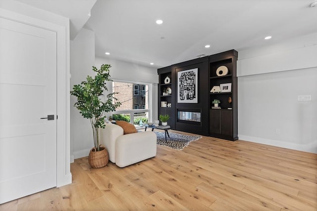 interior space with built in features and wood-type flooring