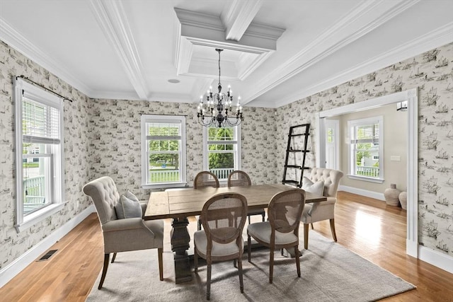 54 Garrison Dr, Scituate, MA 02066 - dining area with wood finished floors, a chandelier, crown molding, wallpapered walls, and baseboards