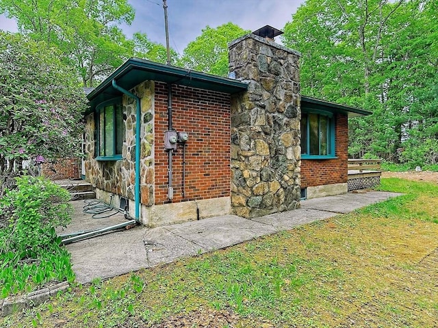 18 Shady Oak Dr, Mattapoisett, MA 02739 - view of side of property featuring brick siding and a chimney