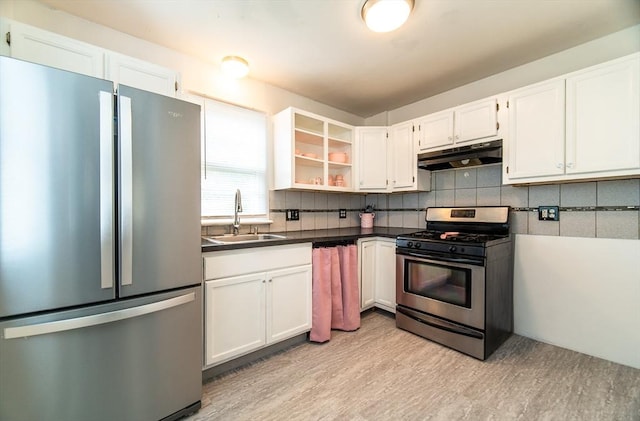 83 Armstrong St, West Springfield, MA 01089 - kitchen with stainless steel appliances, under cabinet range hood, dark countertops, decorative backsplash, and white cabinetry