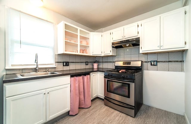 83 Armstrong St, West Springfield, MA 01089 - kitchen featuring stainless steel range with gas stovetop, under cabinet range hood, dark countertops, light wood-style floors, and backsplash