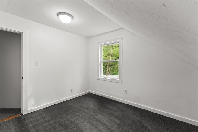 47-49 Dean St, Norton, MA 02766 - unfurnished room with lofted ceiling, dark carpet, and a textured ceiling