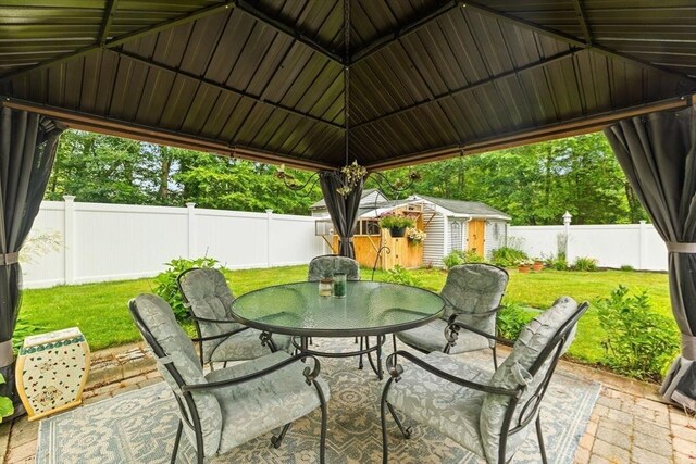 47-49 Dean St, Norton, MA 02766 - fenced backyard featuring a patio, a storage unit, and outdoor dining space