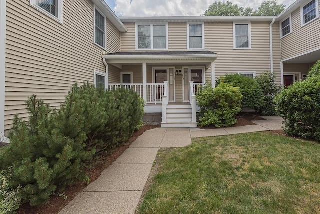 109 Bradford Commons Ln Unit 109, Braintree, MA 02184 - view of exterior entry with covered porch and a yard