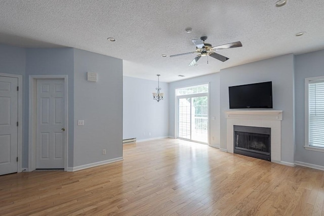 109 Bradford Commons Ln Unit 109, Braintree, MA 02184 - unfurnished living room featuring a textured ceiling, a baseboard radiator, a chandelier, a tile fireplace, and ceiling fan