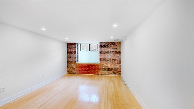 42 8th St Unit 2110, Boston, MA 02129 - unfurnished room with brick wall, light wood finished floors, baseboards, and recessed lighting