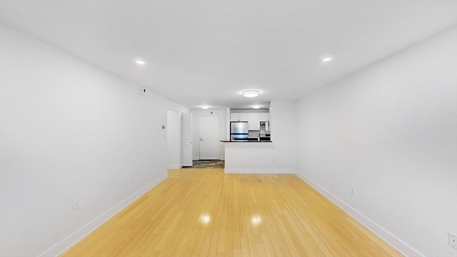42 8th St Unit 2110, Boston, MA 02129 - unfurnished living room with baseboards, light wood-style floors, and recessed lighting