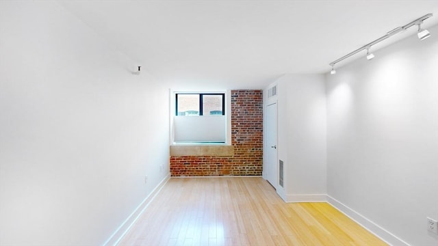 42 8th St Unit 2110, Boston, MA 02129 - empty room with wood finished floors, baseboards, and rail lighting
