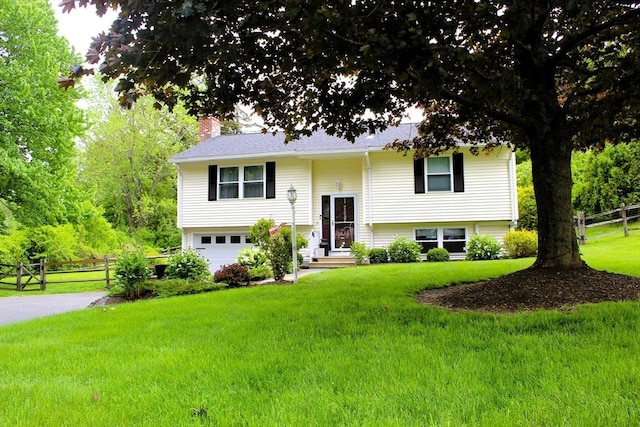 13 Laurana Ln, Hadley, MA 01035 - split foyer home with a chimney, an attached garage, and driveway