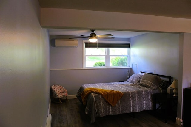 13 Laurana Ln, Hadley, MA 01035 - bedroom featuring an AC wall unit, wood finished floors, baseboard heating, baseboards, and ceiling fan