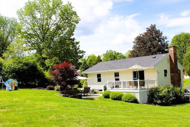 13 Laurana Ln, Hadley, MA 01035 - rear view of property with a yard, a chimney, a patio area, and a wooden deck