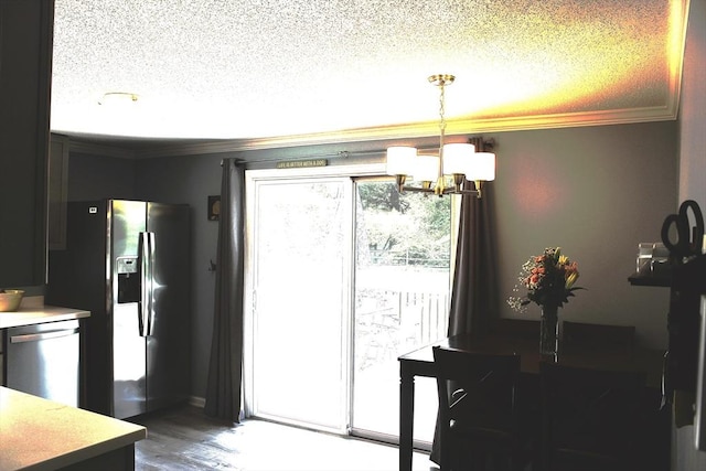 13 Laurana Ln, Hadley, MA 01035 - dining space with a chandelier, crown molding, a textured ceiling, and wood finished floors