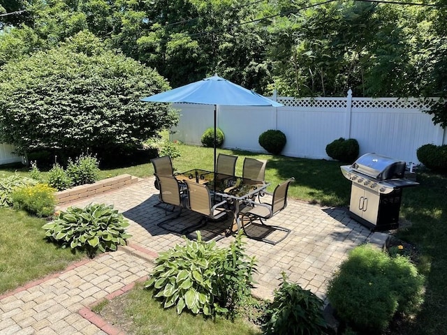 view of patio / terrace featuring area for grilling and fence