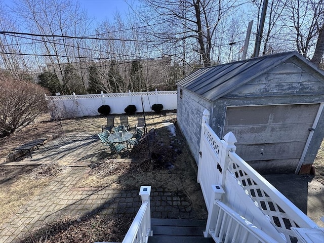 view of yard with an outdoor structure, fence, and a detached garage