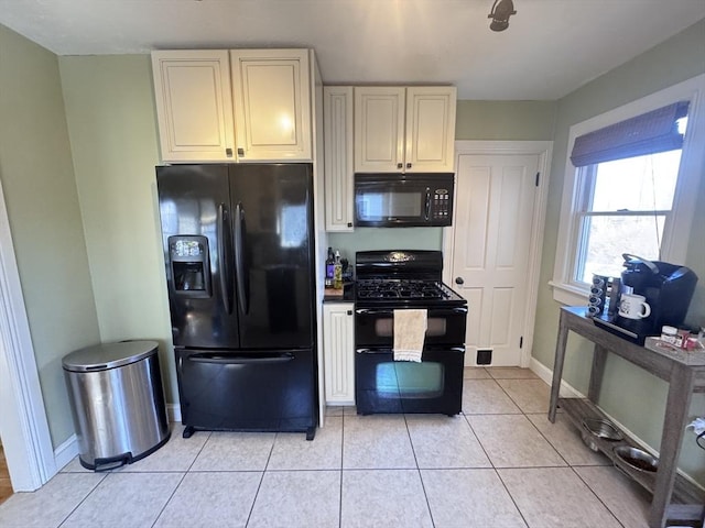 kitchen with black appliances, light tile patterned floors, and baseboards