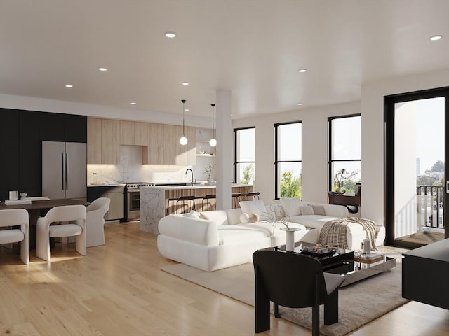 living room with a wealth of natural light, recessed lighting, and light wood-style floors