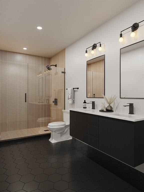 bathroom with toilet, double vanity, a stall shower, tile patterned floors, and a sink