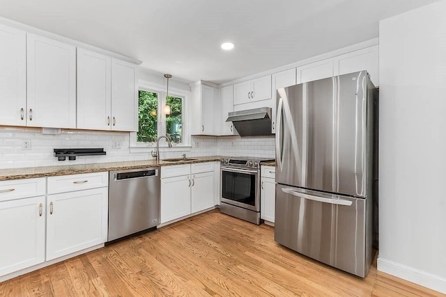 126 Scott Cir, Dedham, MA 02026 - kitchen featuring stainless steel appliances, a sink, white cabinetry, light wood-type flooring, and decorative backsplash