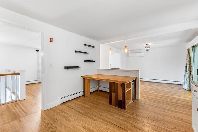 126 Scott Cir, Dedham, MA 02026 - kitchen featuring a baseboard radiator, a wall mounted AC, and light wood-type flooring