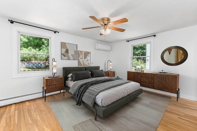 126 Scott Cir, Dedham, MA 02026 - bedroom with an AC wall unit, light wood-type flooring, and ceiling fan