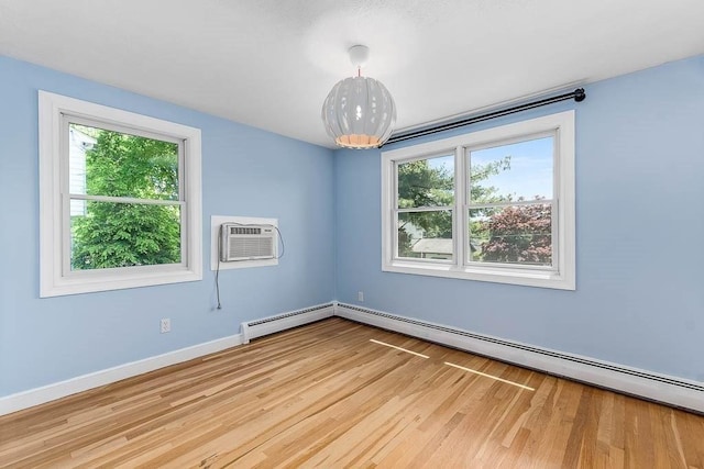 126 Scott Cir, Dedham, MA 02026 - spare room with plenty of natural light, a wall unit AC, wood finished floors, and baseboards