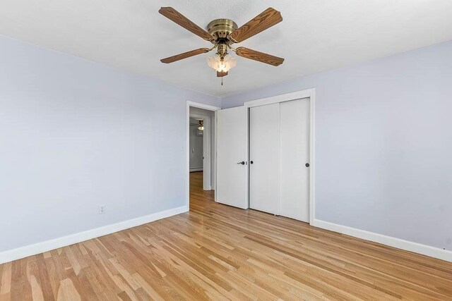 126 Scott Cir, Dedham, MA 02026 - unfurnished bedroom with baseboards, light wood finished floors, a closet, and ceiling fan