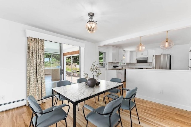 126 Scott Cir, Dedham, MA 02026 - dining room with light wood-type flooring, baseboard heating, and a chandelier