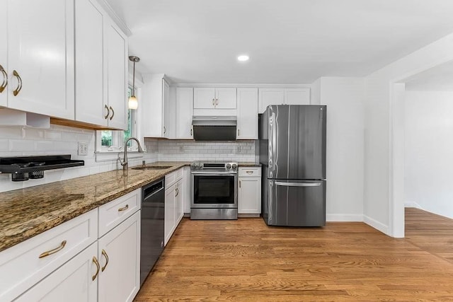 126 Scott Cir, Dedham, MA 02026 - kitchen featuring appliances with stainless steel finishes, a sink, dark stone counters, white cabinetry, and decorative backsplash