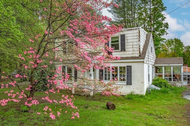 8 N Longyard Rd, Southwick, MA 01077 - view of home's exterior featuring stucco siding, roof with shingles, and a lawn