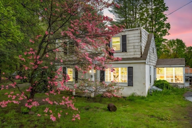 8 N Longyard Rd, Southwick, MA 01077 - view of home's exterior featuring stucco siding and a lawn