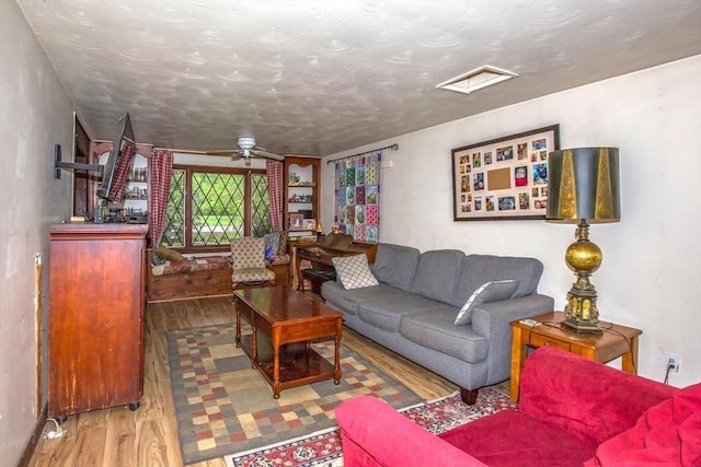8 N Longyard Rd, Southwick, MA 01077 - living area with wood finished floors, a ceiling fan, and a textured ceiling