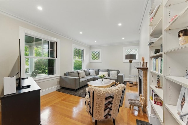18 Alden St, Newton, MA 02459 - living room featuring crown molding, light wood-style flooring, recessed lighting, and a fireplace