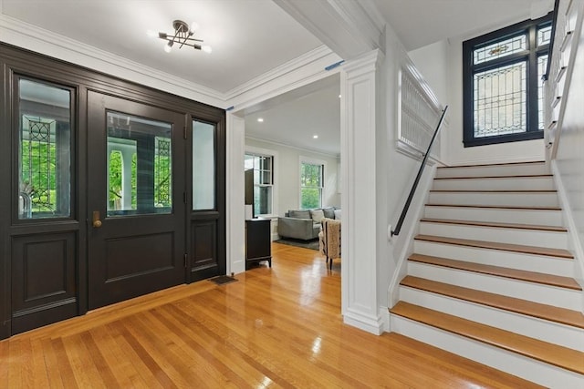 18 Alden St, Newton, MA 02459 - foyer entrance with ornamental molding, stairs, and light wood finished floors