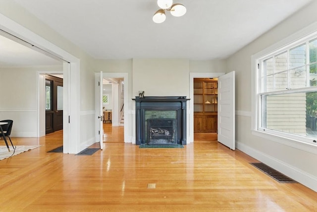 18 Alden St, Newton, MA 02459 - living room with light wood-style floors and a fireplace with flush hearth