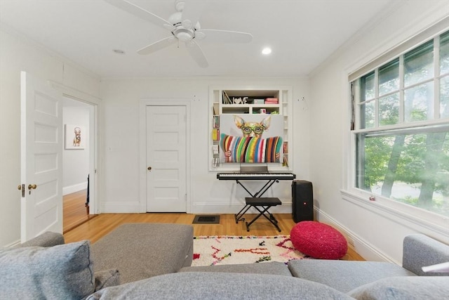 18 Alden St, Newton, MA 02459 - living area featuring ornamental molding, wood finished floors, built in shelves, recessed lighting, and ceiling fan