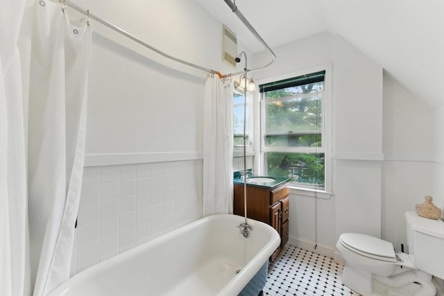 18 Alden St, Newton, MA 02459 - full bath featuring a freestanding bath, healthy amount of natural light, a shower with shower curtain, lofted ceiling, and vanity
