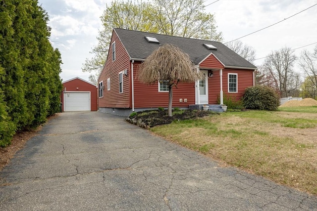 143 Eagle St, Ware, MA 01082 - view of front of property with an outdoor structure, a shingled roof, a garage, driveway, and a front yard