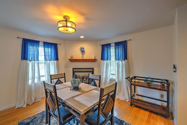 143 Eagle St, Ware, MA 01082 - dining room with a fireplace, recessed lighting, baseboards, and light wood-style floors