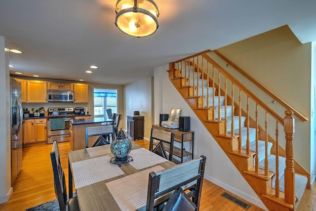 143 Eagle St, Ware, MA 01082 - dining room featuring recessed lighting, stairs, light wood-type flooring, baseboards, and visible vents