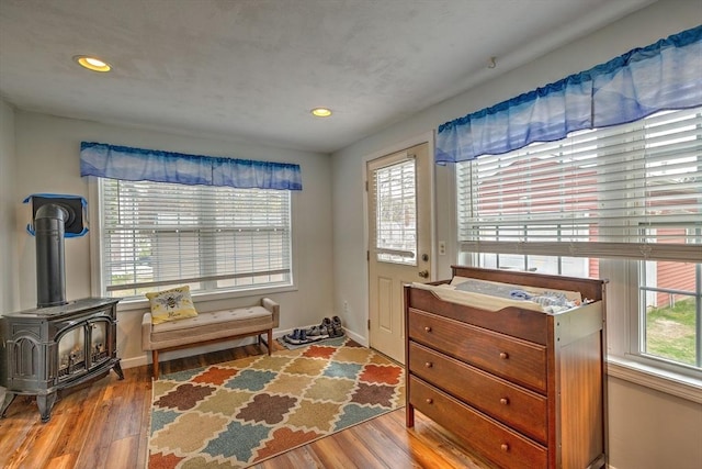 143 Eagle St, Ware, MA 01082 - sitting room with a wood stove, recessed lighting, wood finished floors, and baseboards