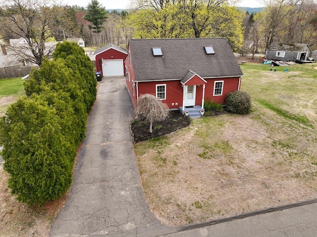 143 Eagle St, Ware, MA 01082 - cape cod home featuring a front lawn, a shingled roof, an outbuilding, a detached garage, and driveway