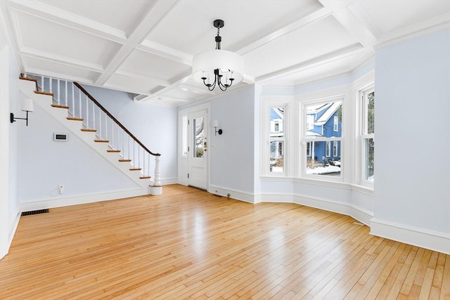 foyer with baseboards, stairway, coffered ceiling, and light wood-style floors