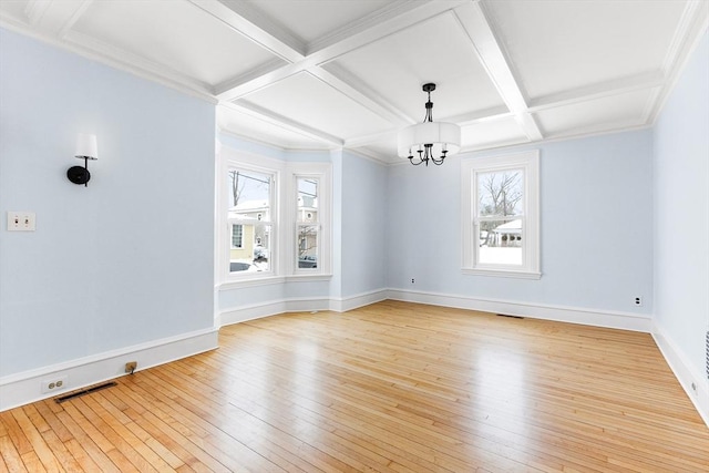 empty room with visible vents, baseboards, coffered ceiling, light wood-style flooring, and a notable chandelier