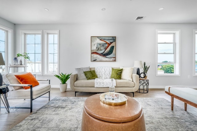 living room with a wealth of natural light and light hardwood / wood-style flooring