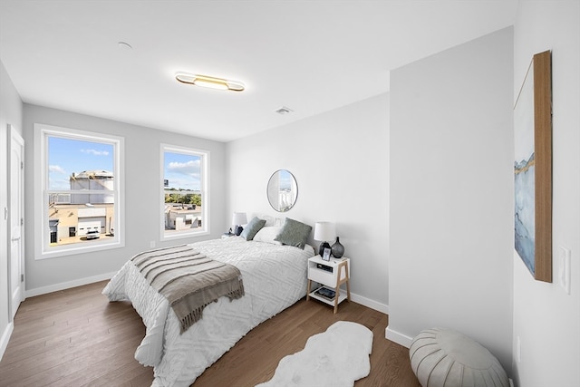 bedroom with dark wood-type flooring